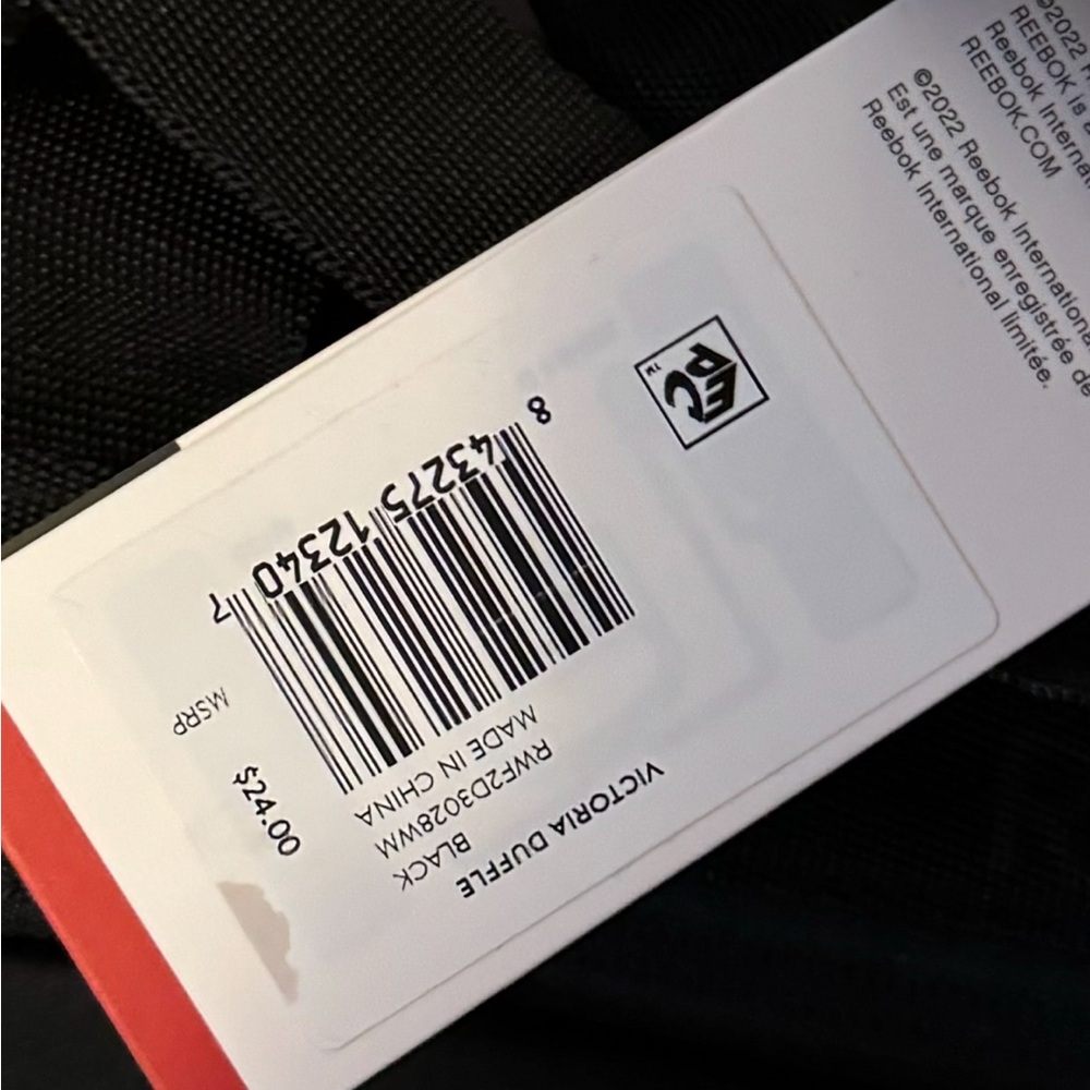 Medium sized (about 12” long) barrel style Reebok purse